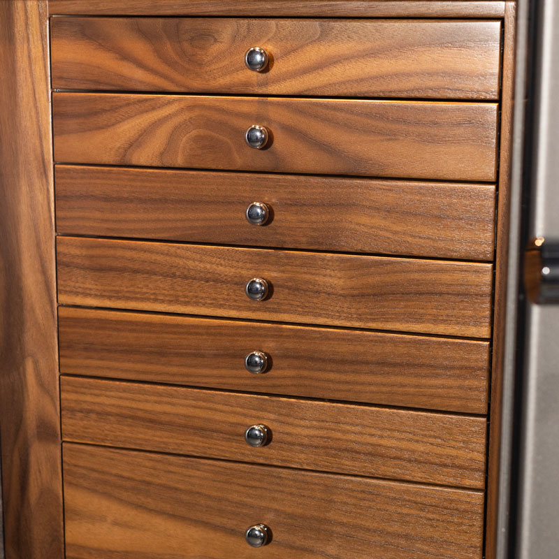 Detail — seven walnut drawers with polished chrome pulls