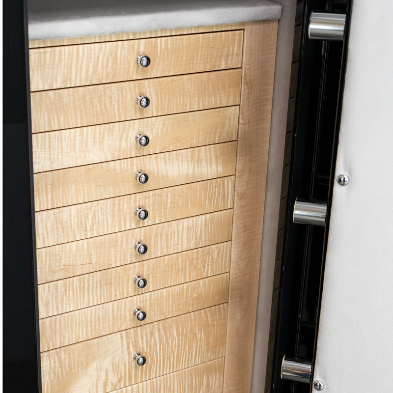 Detail — eleven curly maple drawers with polished chrome pulls