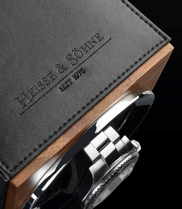 Heisse & Söhne watch winder — embossed leather face with Rolex visible behind the cuff